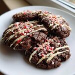 Four fudgy double chocolate peppermint cookies drizzled with white chocolate and topped with crushed candy canes.