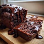 A moist slice of hot fudge brownie bread covered in rich, glossy hot fudge sauce.