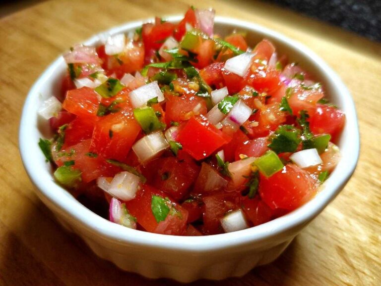Amazing Authentic Pico de Gallo with Lime in 15 Mins Close-up of fresh Authentic Pico de Gallo with Lime, featuring diced tomatoes, onions, and cilantro in a small white bowl.