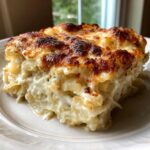 A rich, creamy slice of Cabbage Alfredo with Parmesan Crust, featuring a deeply browned, cheesy top.