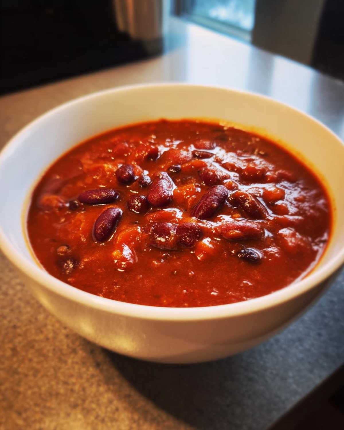 Close-up of a hearty bowl of rich, red Pantry Staple Chili with Beans.