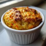 Close-up of warm Single-Serving Carrot Cake Baked Oats baked golden brown in a white ceramic ramekin.